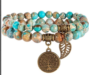 Close-up of double-layer ocean jasper beaded bracelet with tree of life and leaf charms