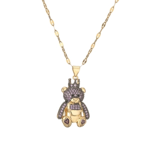 Detailed macro view of the golden crown bear pendant with purple sparkling rhinestones