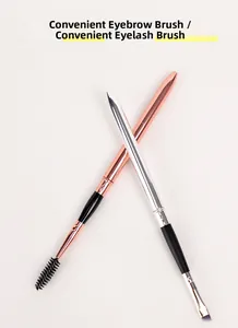 Macro shot of portable rose gold and silver eyelash brush with angled eyebrow brush tool