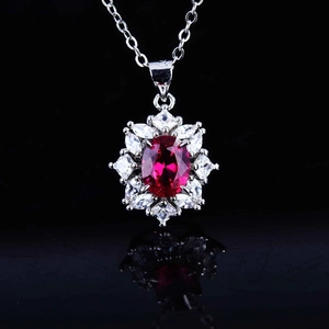 Close-up of S925 sterling silver necklace with a large oval red ruby pendant and zircons