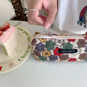 Detail of floral corduroy pencil case with vintage flower pattern and zipper closure