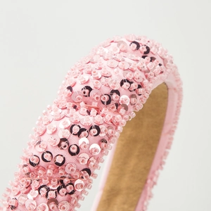 Pink sequin handmade headband with wave design and luxury beadwork on a white background