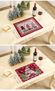 Detail of Christmas gnomes placemat with red black plaid border and jacquard texture