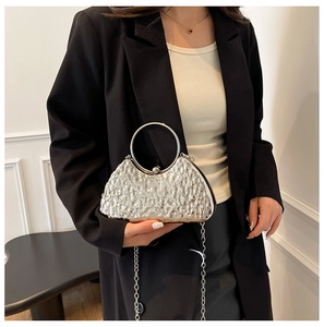 Silver evening bag with crinkled texture, round metal handle and delicate chain strap