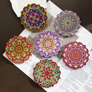 Set of six gold-stamped bohemian mandala ceramic coasters with vibrant multicolor patterns