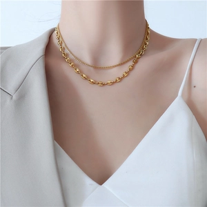 Close-up of gold layered pig nose necklace on model showcasing the elegant double chain detail