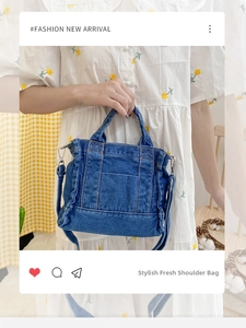 Detail of blue denim shoulder bag featuring yellow stitching and adjustable metal buckle strap