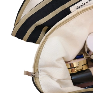 Striped cotton canvas makeup bag with brown stripes and metal zipper closure