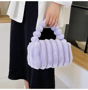 Close-up of lavender faux fur handbag featuring soft striped plush texture and handle detail