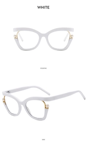 Detailed close-up of white cat-eye frames with elegant golden pearl accents on side