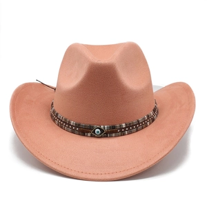 Detail of pink wide brim cowboy hat with ethnic band and blue evil eye charm