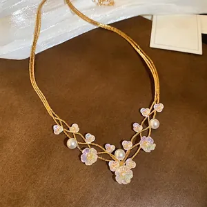 Three-layer gold necklace with resin flowers and pearls, elegant vintage floral design