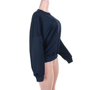 Side view detail of a loose dark blue long-sleeve sweatshirt with drop shoulder design