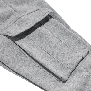Detail shot of men's heather gray joggers featuring side pocket flap and knit cotton texture
