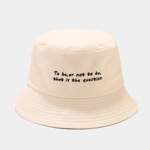 Detail of cream fisherman hat with embroidered black literary text and reinforced stitching