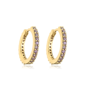 Detailed view of gold hoop earrings with small purple zircon stones on white background