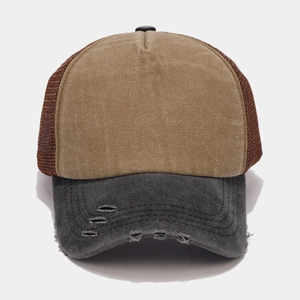Detail of vintage washed trucker hat featuring a distressed brim and breathable mesh