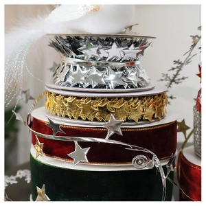 Detail of velvet ribbons and gold star garlands for Christmas tree decoration