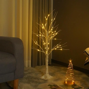 Detailed close-up of warm LED lighted birch tree lamp for indoor Christmas home decoration