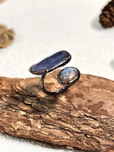 Macro view of vintage style adjustable ring with rough purple stone and blue labradorite