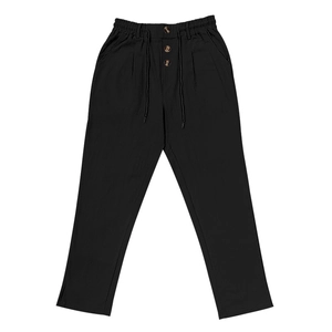 Detail of men's black linen trousers featuring amber textured buttons and drawstring waist