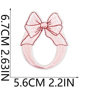 Pink bow embroidery patch with red border detail showing dimensions 6.7cm x 5.6cm