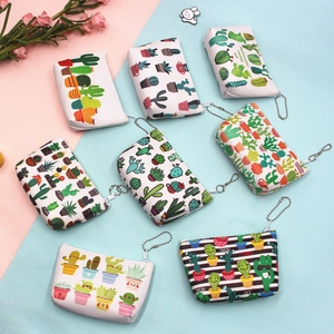 Flat lay of cactus pattern PU leather coin purses with silver zippers and bead chains