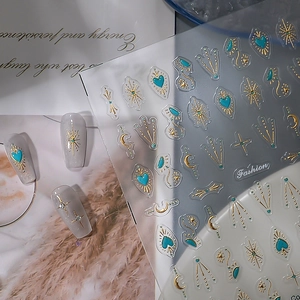 Detail of turquoise and gold star moon totem nail stickers with bohemian vintage design