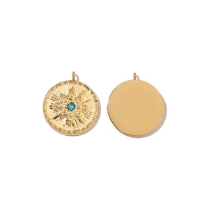 Detailed view of two gold pendants featuring sunburst relief and a blue gemstone inlay