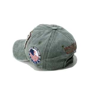 Detail view of washed denim baseball cap featuring vintage America embroidery and side patch