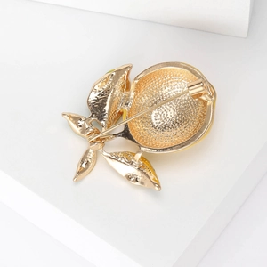 Golden enamel lemon brooch with realistic fruit texture and 925 stamp on white background