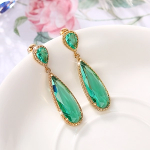 Elegant gold drop earrings with emerald green teardrop stones and shimmering crystals