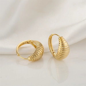 Chic 14K gold plated ribbed hoop earrings on white silk background professional view