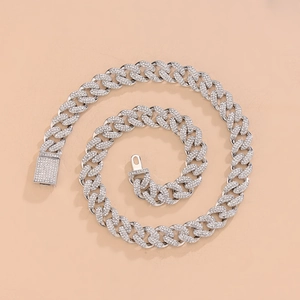 Macro detail of silver hip hop Cuban link chain with square rhinestone pave clasp