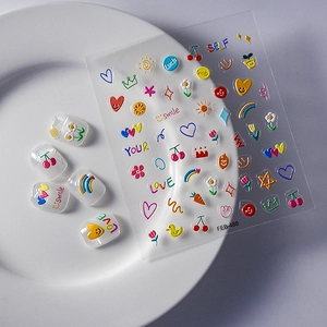 Detail of 3D embossed nail stickers featuring colorful hearts and cute icons