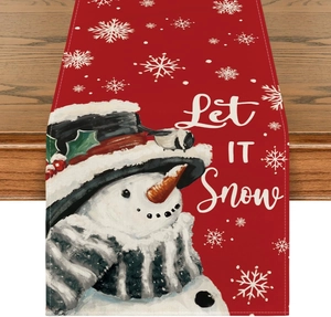 Detailed view of red Christmas table runner with snowman and Let It Snow lettering