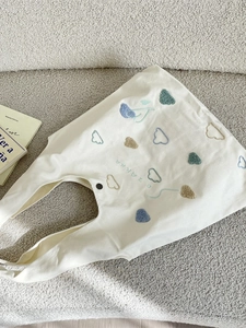 Minimalist canvas tote bag with colorful cloud embroidery and magnetic snap button