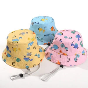 Detail view of cartoon dinosaur bucket hats in yellow, blue, and pink with adjustable wind ropes