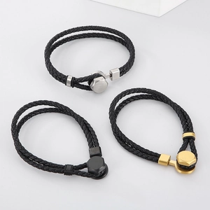 Detailed view of woven leather bracelets with silver, gold, and black metal magnetic clasps