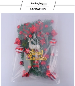 Detailed view of Christmas elk ornaments and red baubles set in plastic packaging