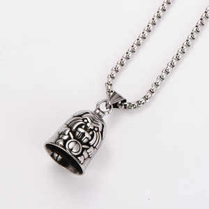 Macro shot of silver retro tiger bell pendant on a polished box chain necklace