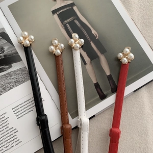 Detail of adjustable pearl buckle leather belts for women in four elegant colors
