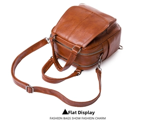 Vista superior detallada de mochila de cuero marrón con cremalleras y texturas finas