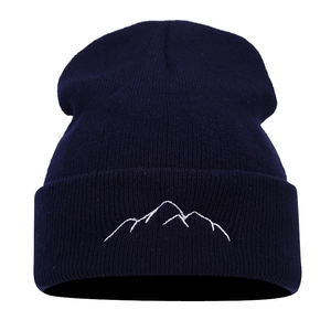 Navy blue knit beanie with white mountain peak embroidery and ribbed cuff design