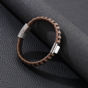 Detail of woven leather bracelet with brushed metal magnetic clasp for men's casual style