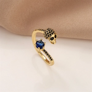 Macro shot of skull ring with blue center stone and black micro-inlaid zircon detail
