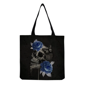 Detailed macro view of the canvas texture and Gothic skull floral print on the black tote