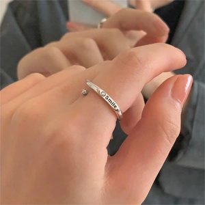 Detailed close-up of a silver 925 adjustable ring with a Smile engraving and smiley icon