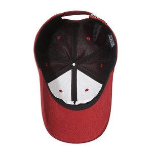 Inside view of a deep red cotton baseball cap showing stitching and adjustable buckle