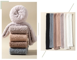 Close-up of thick coral fleece over-knee socks in multiple colors with soft texture